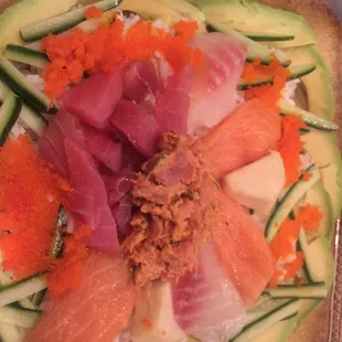 a plate of sushi and cucumbers
