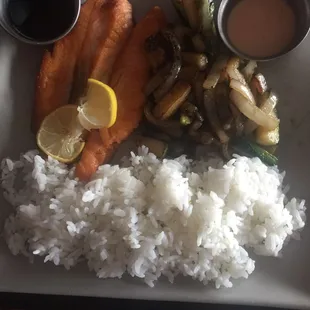 a plate of rice, salmon, and vegetables