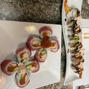 a plate of sushi and a plate of rolls