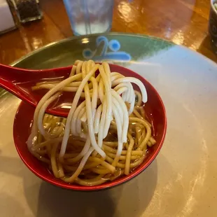 &quot;Chicken soup&quot; with what appears to be spaghetti noodles