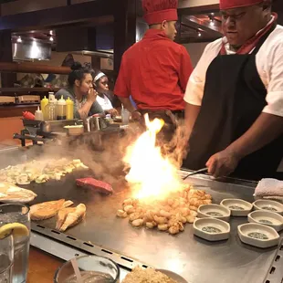 The chef preparing to make a smoke stack from a train with the onions!
