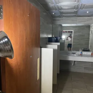 Men&apos;s room was lit by a reflector lamp clamped to the door.