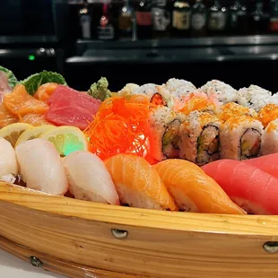 a wooden boat filled with sushi