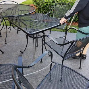 The photo is of their patio.  The gentleman is my 91 year old neighbor, trying to sit, but he can't.