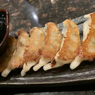 a plate of fried food with dipping sauce