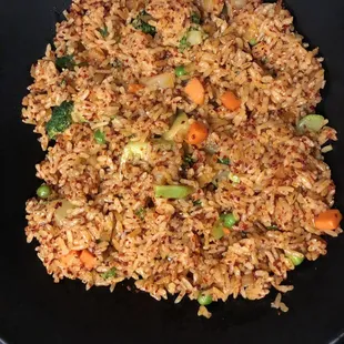 a plate of fried rice and vegetables