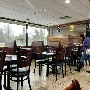 a woman walking through the dining area