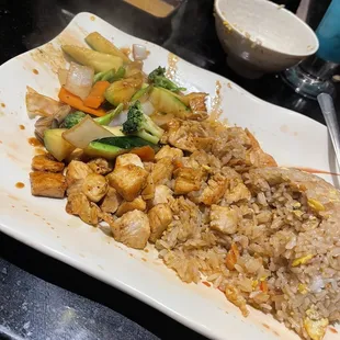 a plate of fried rice and vegetables