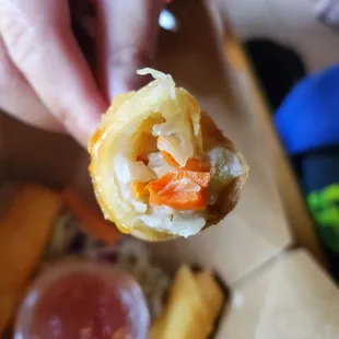 a hand holding a piece of food