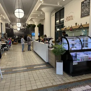 people sitting at tables in a coffee shop