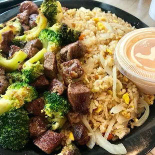 a plate of rice, broccoli, and beef