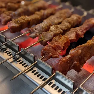 skewered meat on a grill