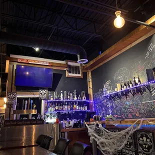 a bar with a chalkboard wall