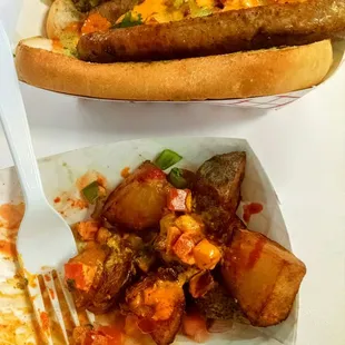 Argentinean sausage with chimichurri and pico de gallo, and half of patatas bravas