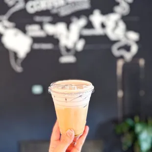 a hand holding a cup of coffee