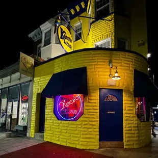 a neon sign on the corner
