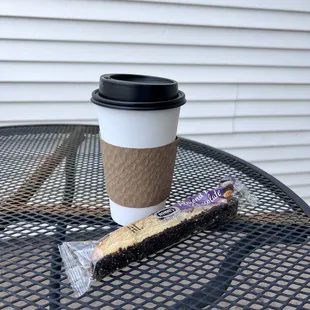 a cup of coffee and a brush on a table