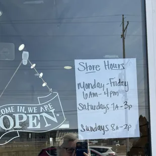 a sign in the window of a coffee shop