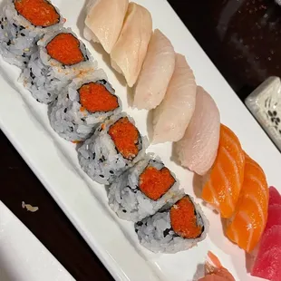 a variety of sushi on a white plate