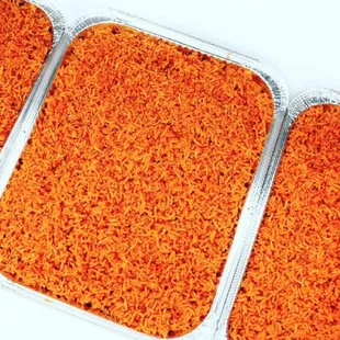 three trays of cooked carrot rice