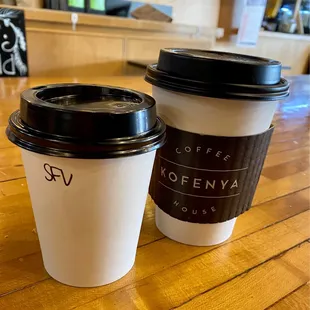 two coffee cups on a wooden table