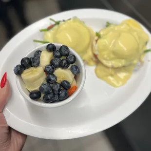 a person holding a plate of food