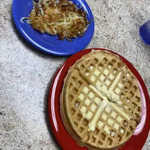 a waffle and a plate of hash browns