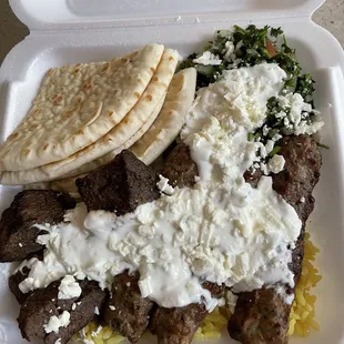 Mix Grill Plate (3 lamb kabab &amp; 4 lamb chunk pieces) w rice &amp; tabbouleh. Covered in tzatziki &amp; feta.