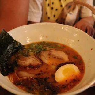 a closeup of a bowl of ramen with an egg
