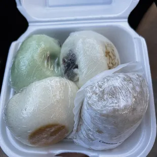 four onions wrapped in plastic wrap