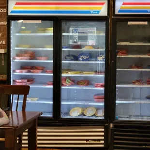 a child sitting at a table in front of a refrigerator