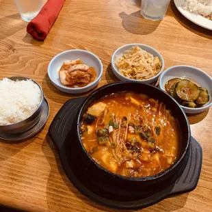 a bowl of soup and bowls of rice