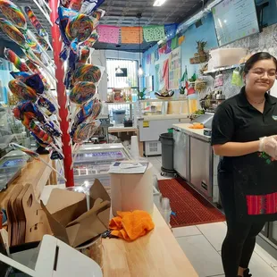 a woman standing in a kitchen