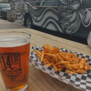 a plate of fries and a glass of beer