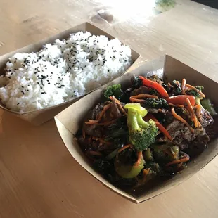 a box of rice and a bowl of broccoli