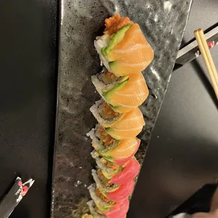 a sushi roll with salmon and avocado