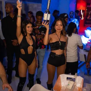 a woman in a bikini holding a bottle