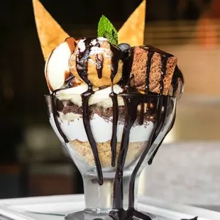 Signature Koi Sundae with profiterole and warm brownies drizzled in hot fudge.
