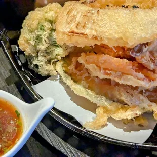 The shrimp tempura is under the onion ring