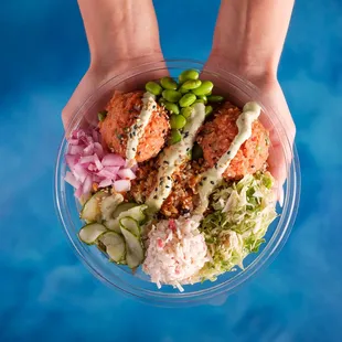 a person holding a bowl of food