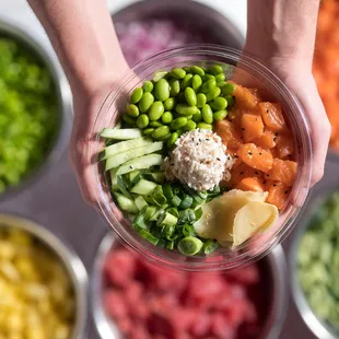Salmon Signature Bowl - Salmon, house sauce, cucumber, edamame, green onion, ginger, crab mix, &amp; sesame seeds.