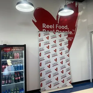 a red and white sign with a heart on it