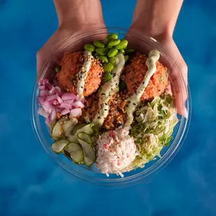 a person holding a bowl of food