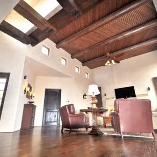 a spacious living room with high ceilings