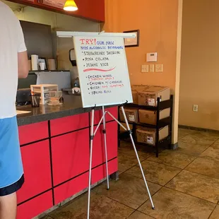 a man standing in front of a sign