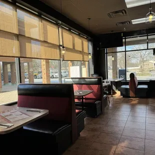a woman sitting at a table in a restaurant