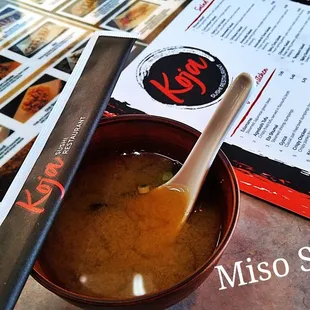 a bowl of miso soup with a spoon