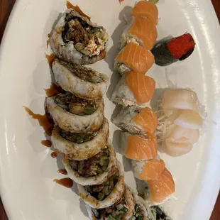 Spider roll in the front, Michigan roll in the middle, scallop sashimi in the back along with tobiko nigiri