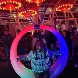 a kid standing in an inflatable ring