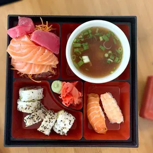 a bento box with a variety of sushi